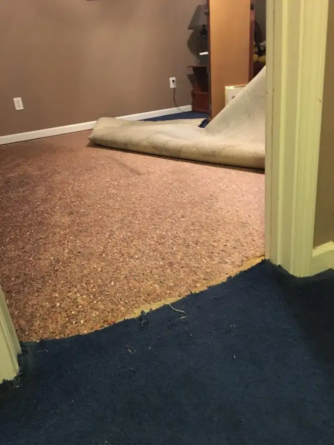 Carpet pad removal revealing water damage during Water Mitigation Services in Powdersville